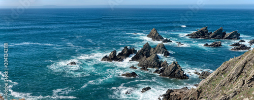Stunning view of sharp rock formations and cliffs in the blue ocean from the Loiba viewpoint, where the so-called 