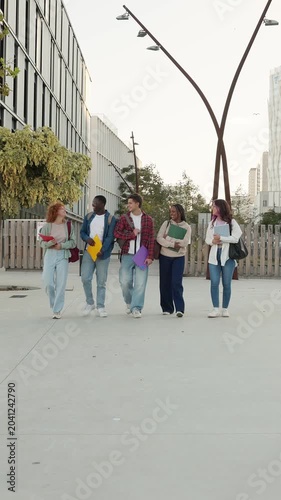 Diverse group of university students walking together on campus