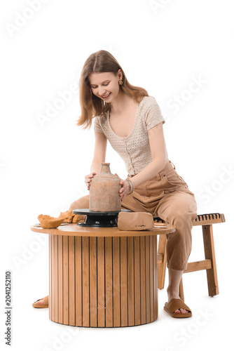 Female sculptor shaping cla...