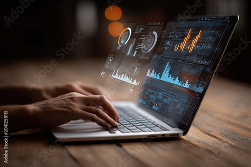 Hands typing on laptop displaying financial data and charts.