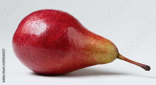A single ripe red pear with a smooth shiny skin and a stem on a white background.