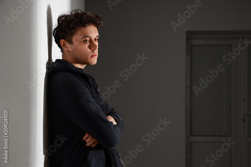 Sad young man in dark hall....