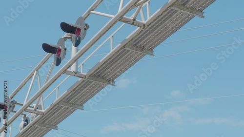 Railway signaling lights mounted on overhead metal truss gantry structure