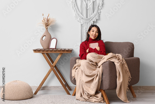 Young happy Asian woman wit...