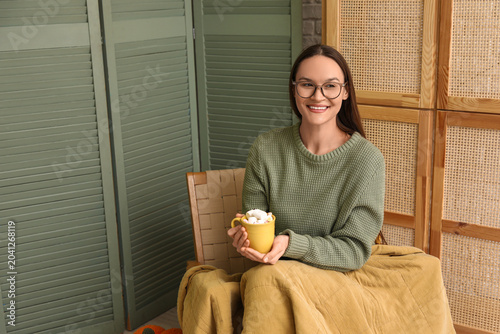 Young happy woman with cup ...