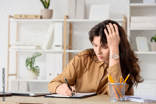 Tired young businesswoman w...