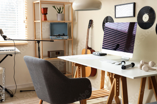 Interior of recording studio with workplace and musical instruments