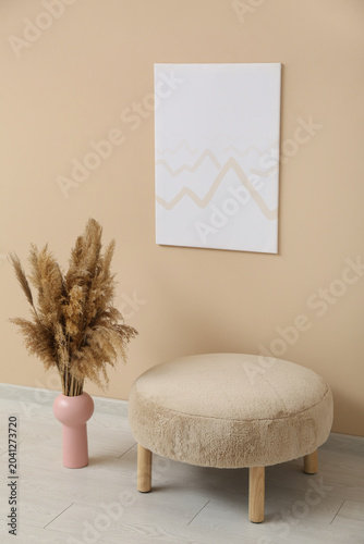 Painting hanging on beige w...