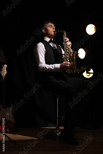 Male artist playing saxopho...