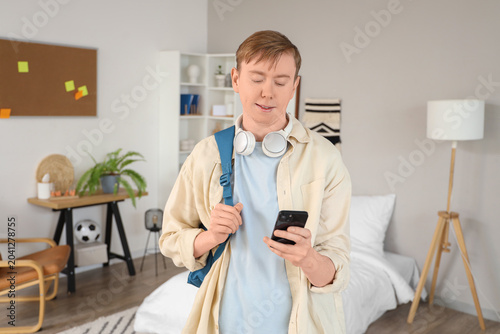 Male student using mobile p...