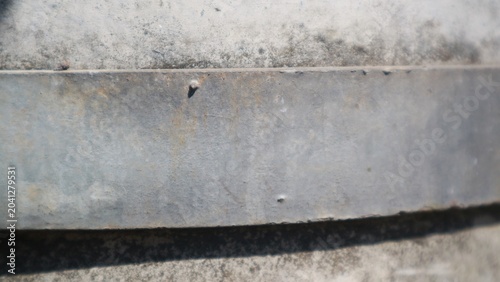 Close-up of a weathered metal surface with a textured background