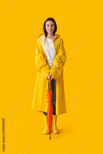 Young happy woman in rainco...