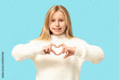 Cute little girl showing he...