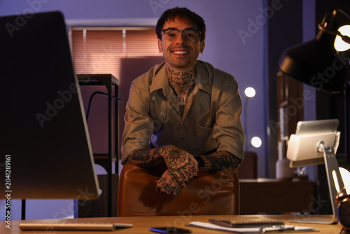 Young tattooed man working ...
