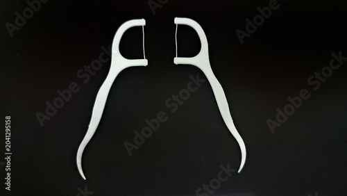Bild auf Leinwand white dental floss picks isolated on black background