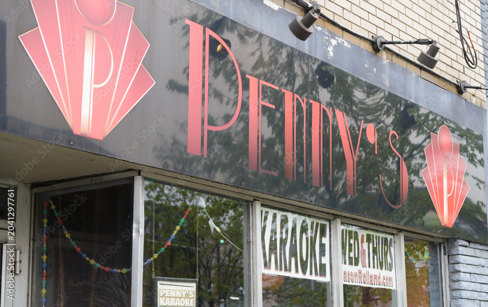 Naklejka premium sign outside Penny's, a bar, located at 1306 Bloor St W, Toronto