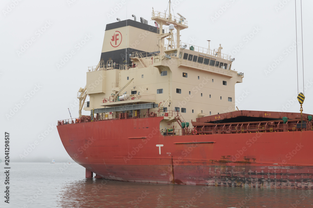 Naklejka premium The Federal Thunder Bay, a modern bulk carrier ship, docked at the Redpath Sugar Refinery in Toronto - deckhouse or superstructure