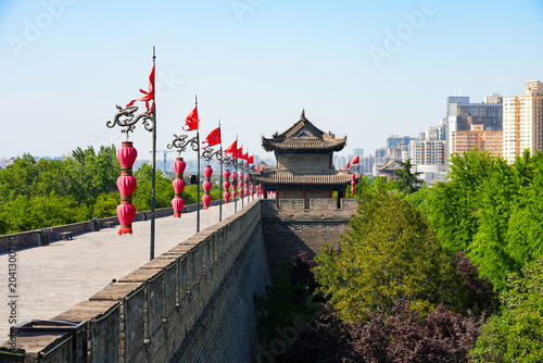 Perspective view of the ancient massive stone wall and watchtower adorned with red lanterns in Xi'an, Shaanxi, China