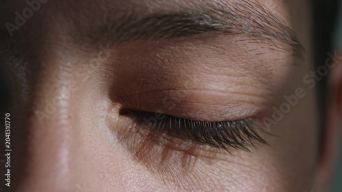 Extreme close up of a closed human eye with focus on eyelashes