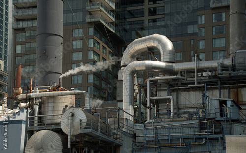 Industrial Pipes and Steam Against Seattle High-Rises