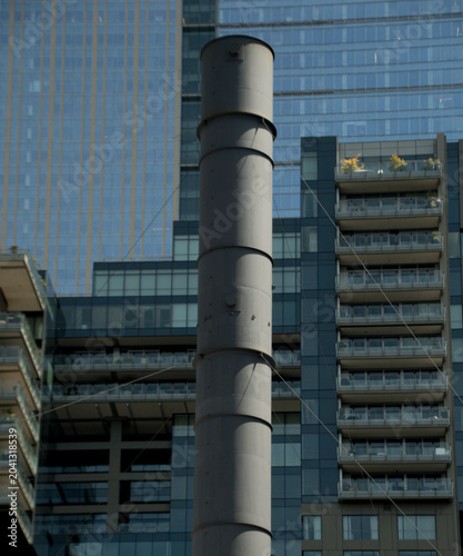 Industrial Stack Framed by Modern Seattle Residential Towers