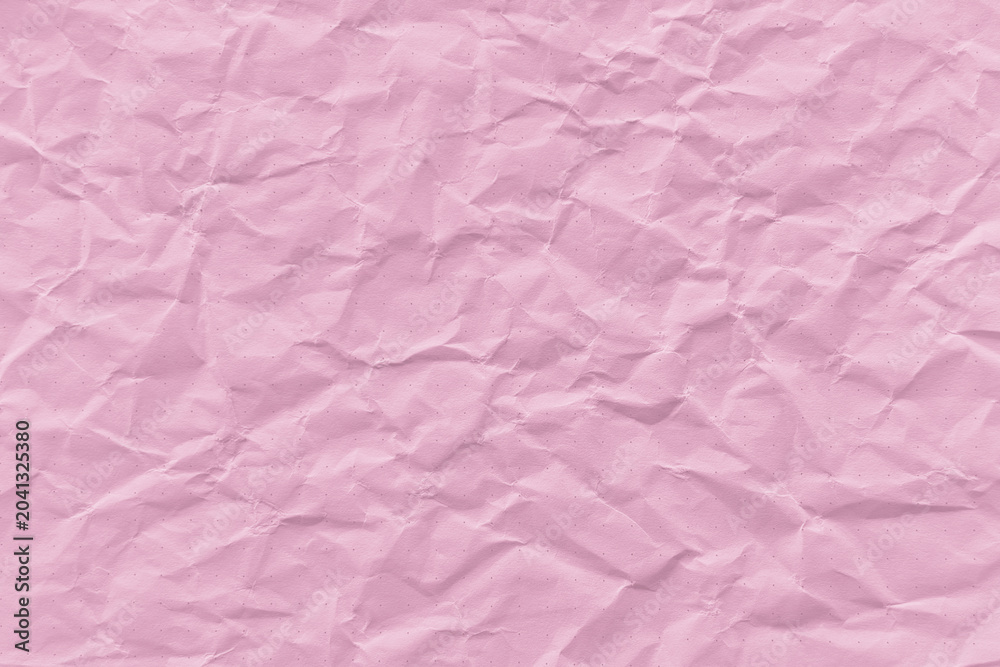 Fototapeta premium Crumpled pink paper texture with visible creases and folds.