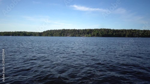 Stockholm, Sweden A view of the water of Lake Malaren from a moving motorboat on a sunny summer day. 