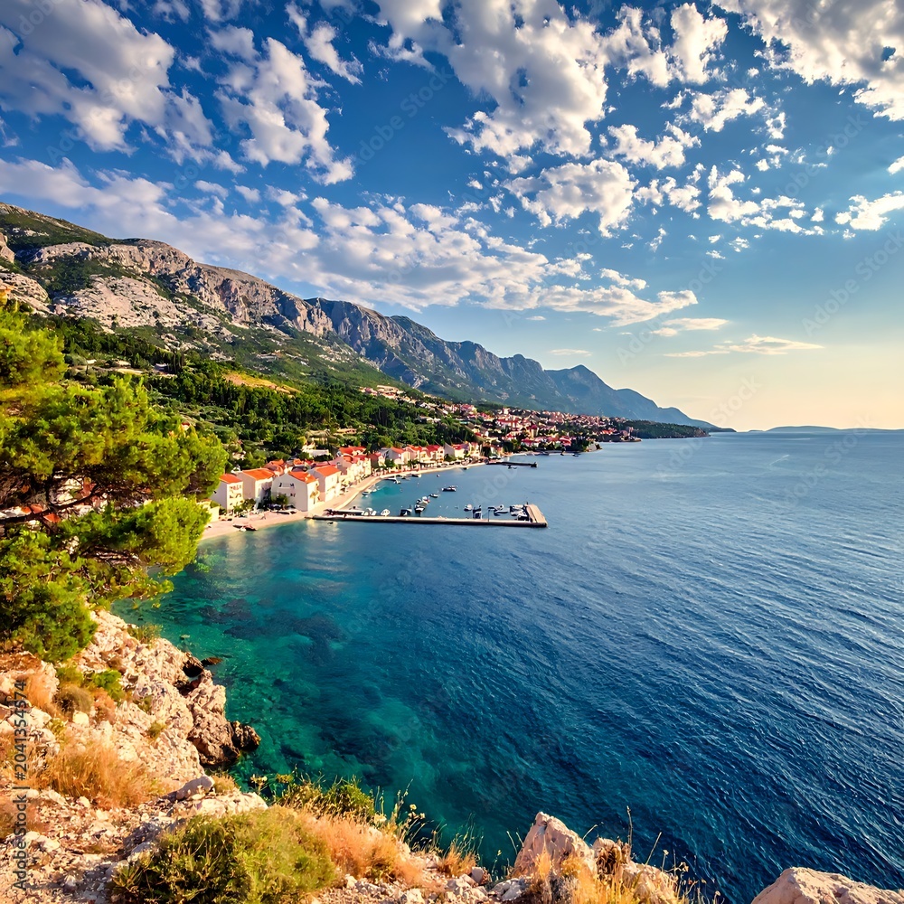 Fototapeta premium Scenic coastal town on rocky shoreline.