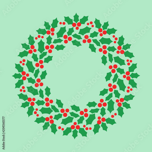 A festive circular wreath made of green leaves and red berries