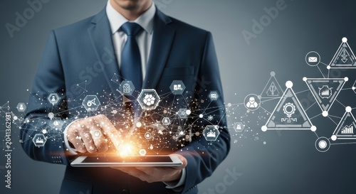 Businessman interacting with a digital tablet displaying a complex network of business icons and data nodes