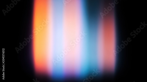 Abstract light streaks in soft hues of orange, blue, and pink on a dark background.