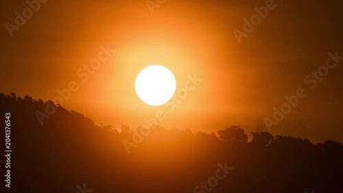Peaceful morning time-lapse of sunrise in the mountains, soft clouds moving over a high altitude landscape.