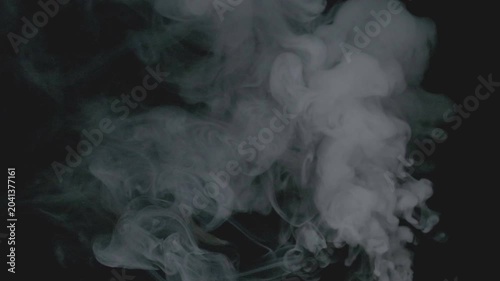 Real white smoke slow motion isolated on black background.