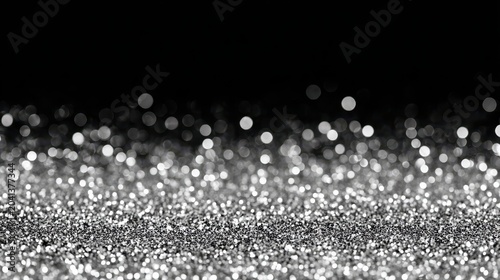 Shimmering silver bokeh background with sparkling glitter effect.