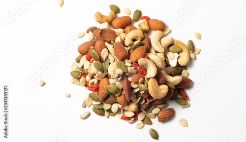 mixed organic cereal and grain seed pile on white background. healthy eating concept. pumpkin, sunflower seeds and legumes.