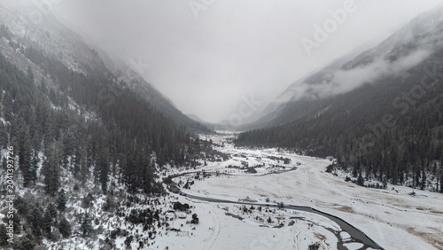 Photos Aerial panoramic winter scenery of snow mountain valley in Bailang Valley, Nying