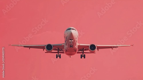 Airplane approaching landing gear down against a vibrant sunset sky background captured in high quality professional aviation motion video footage