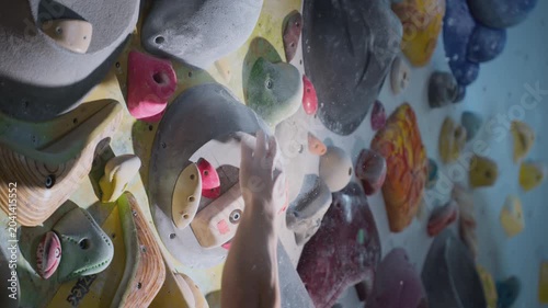 Extreme close-up, hand grabs the ledge, clings to the fingers. Breaks off the ledge, failure. Strong experienced athlete practices bouldering wall climbing inside a gym. Sports lifestyle. Slow motion