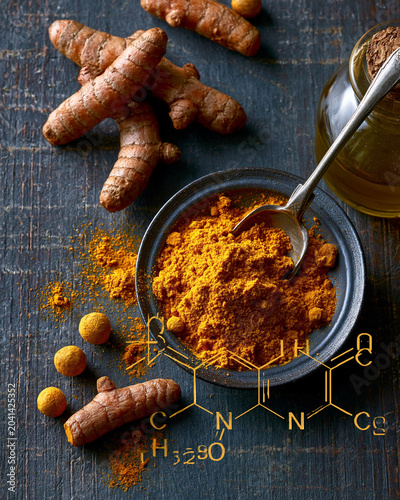 Turmeric roots and powder with curcumin molecular structure overlay for antioxidant wellness and food chemistry concept