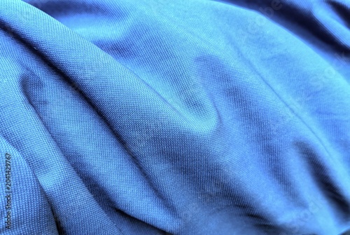 Close-up of wrinkled blue synthetic fabric texture background