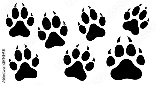 Photos Black animal paw prints on white.