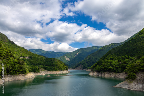 山肌が迫る深い渓谷の間に広がる長島ダムの接岨湖