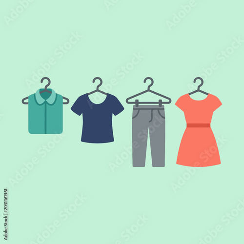 A set of colorful clothing items hanging on plastic hangers