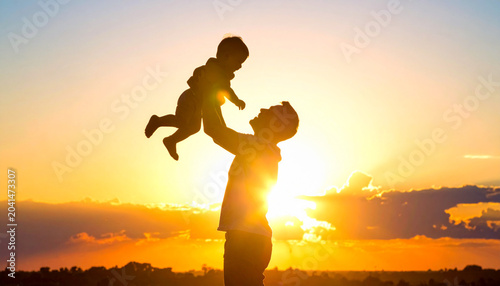 Happy family silhouette at sunset