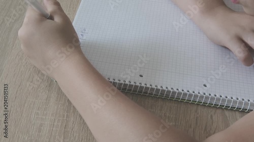 Close up Student kid hand writing letter notebook, practicing handwriting strokes, literacy and school, child training, concentration and homework, Developing fine motor skills, hand-eye coordination