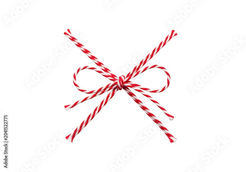 Decorative red and white striped twine tied in a neat bow knot for gift wrapping and festive holiday craft projects on a clean dark background isolated on a transparent background