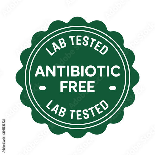 Green scalloped circular seal with text lab tested and antibiotic free guarantee