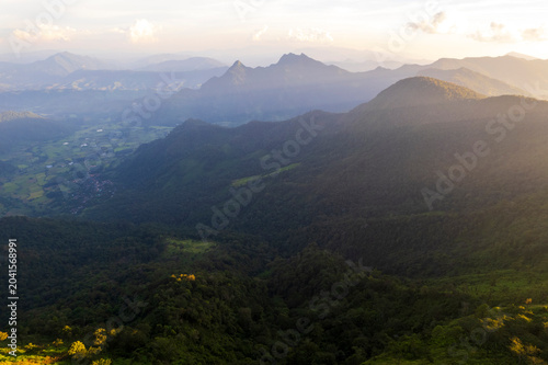 Landscape of Morning Mist with Mountain Layer. mountain ridge and clouds in rural jungle bush forest