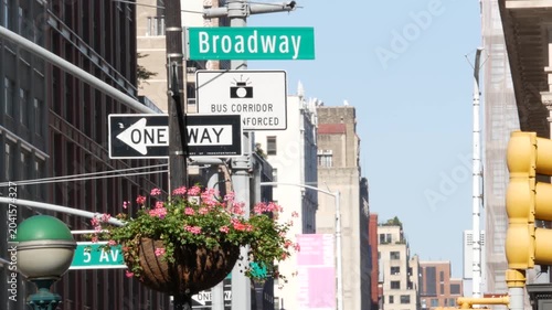 New York City Broadway street sign in Manhattan Midtown, United States. Urban road sign, traffic sign. Building architecture in Flatiron district. Crossroad with 5 fifth avenue. Subway metro entrance