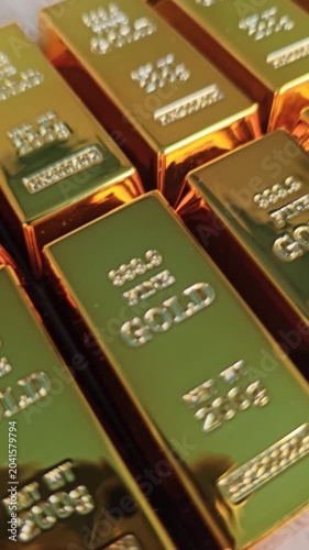 Gold bars stacked in a neat arrangement showing their weight and purity in clear detail